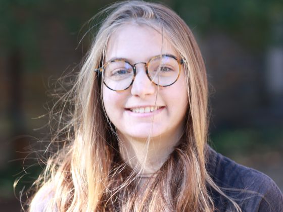 frontal view of face of woman with glasses and long hair