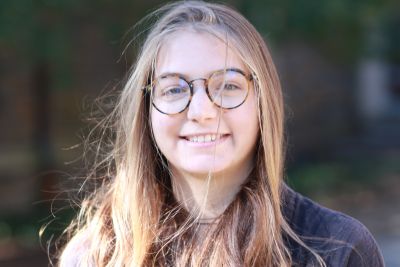 frontal view of face of woman with glasses and long hair