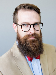 Portrait of a bearded man with glasses.